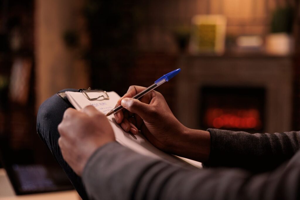 Therapist taking notes during counseling session